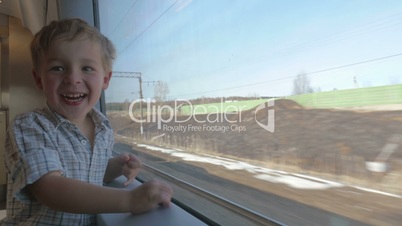 Boy Waving Hand out of the Train Window