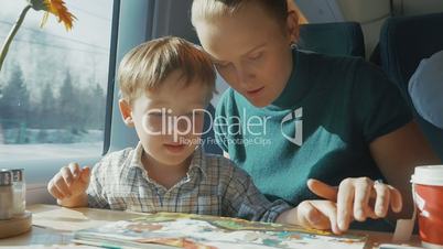 Mother and son with childrens book in the train