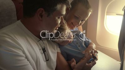 Child with parents traveling by plane