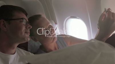 Couple Taking Selfie in the Plane