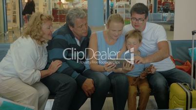 Big Family with Tablet in Waiting Room