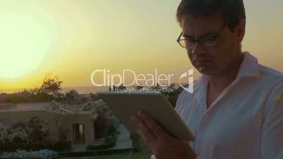 Man with Tablet PC at Sunset