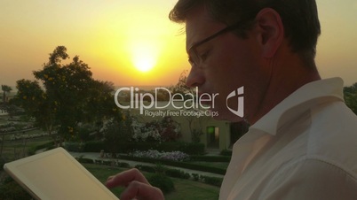 Work on business with pad outdoor at sunset