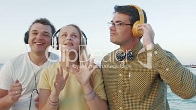 Friends Listening to the Music in Headphones