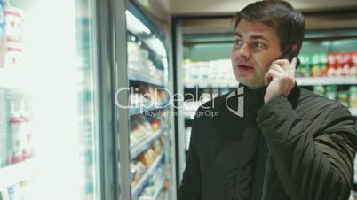 Man Talking on the Phone in Food Store