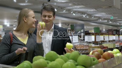 Couple Choosing Apples in Grocery Store