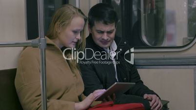 Couple with Tablet PC in Public Transport
