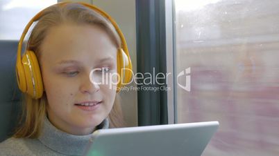 Woman in Headphones Listening to Music on the Way