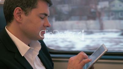 Businessman Traveling by Train with Tablet PC