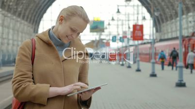 Woman with Tablet on the Railway Station