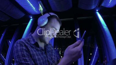 Young Man Enjoying the Music in Tablet