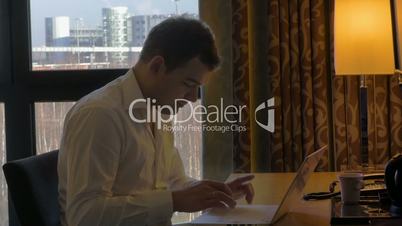 Businessman with Laptop at Work Desk