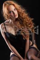 Young Red- Haired Woman In Black Lingerie