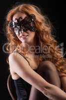 Young Red- Haired Woman In A Black Mask