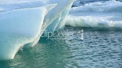 Ice block breaks down at the glacier lagoon Jokulsarlon in slow motion
