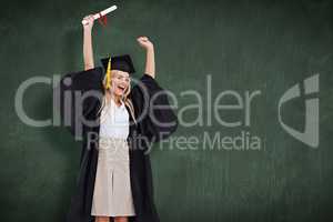 Composite image of blonde student in graduate robe holding up he