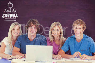 Composite image of a group of students with a laptop look into t