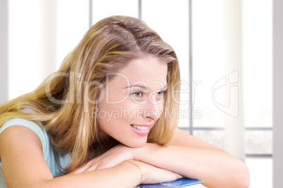 Composite image of thoughtful pretty female student in library