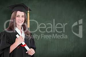 Composite image of a smiling woman with a degree in hand as she