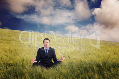 Composite image of calm businessman sitting in lotus pose