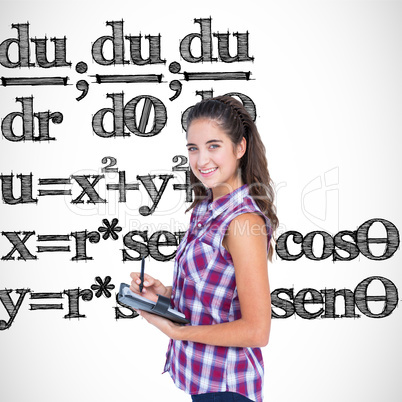 Composite image of pretty brunette writing on notebook