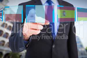 Composite image of businessman pointing his finger at camera