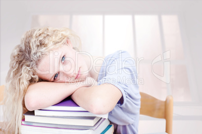 Composite image of tired teeenager sleeping in a library