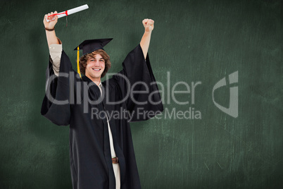 Composite image of male student in graduate robe raising his arm