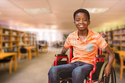 Composite image of portrait of boy sitting in wheelchair at libr