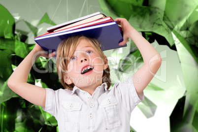 Composite image of cute pupil holding books