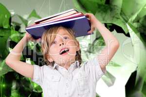 Composite image of cute pupil holding books