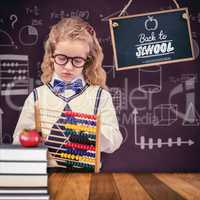 Composite image of pupil holding abacus at elementary school