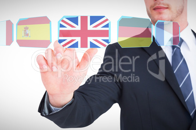 Composite image of focused businessman pointing with his finger