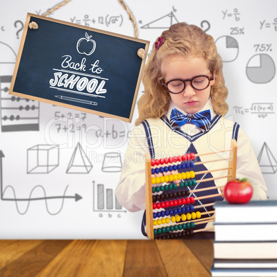 Composite image of pupil holding abacus at elementary school