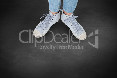 Composite image of woman wearing trainers