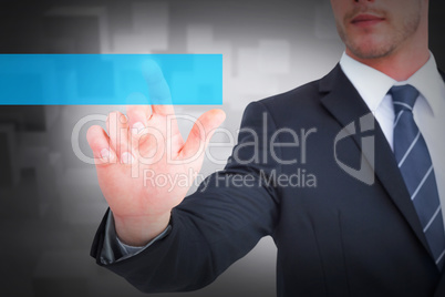 Composite image of focused businessman pointing with his finger