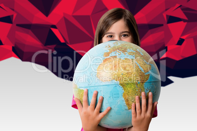 Composite image of cute pupil smiling holding globe