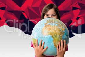 Composite image of cute pupil smiling holding globe