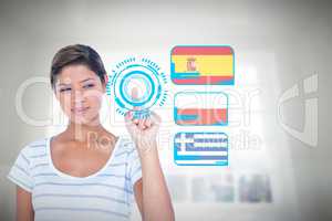 Composite image of beautiful woman touching invisible screen