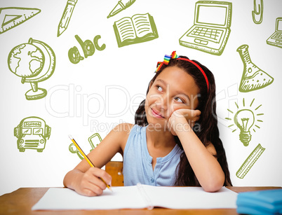 Composite image of cute pupil at desk