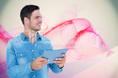 Composite image of handsome man holding digital tablet over whit