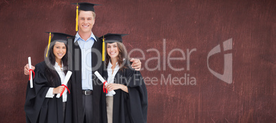 Composite image of full length of three friends graduate from co