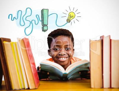 Composite image of cute boy reading book in library