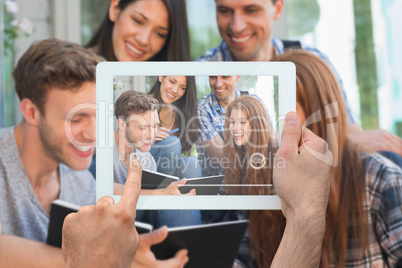 Composite image of hand holding tablet pc