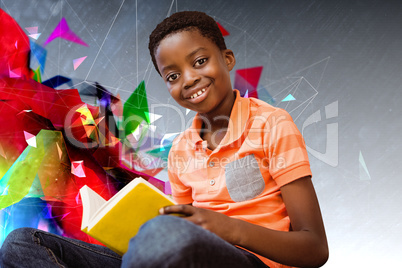 Composite image of cute boy reading book in library