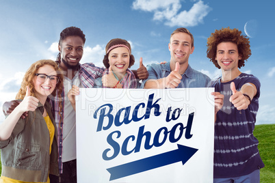 Composite image of fashion students smiling at camera together