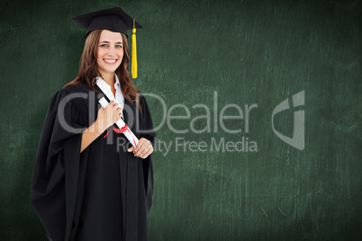 Composite image of a smiling woman with her degree as she looks