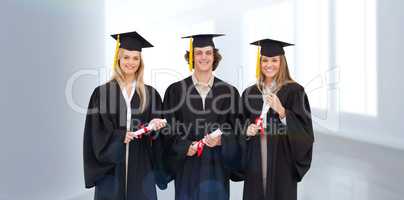 Composite image of three students in graduate robe holding a dip