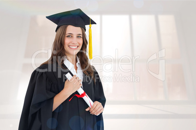 Composite image of a smiling woman with her degree as she looks