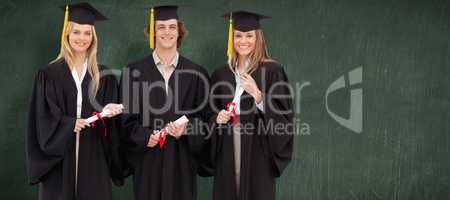 Composite image of three students in graduate robe holding a dip